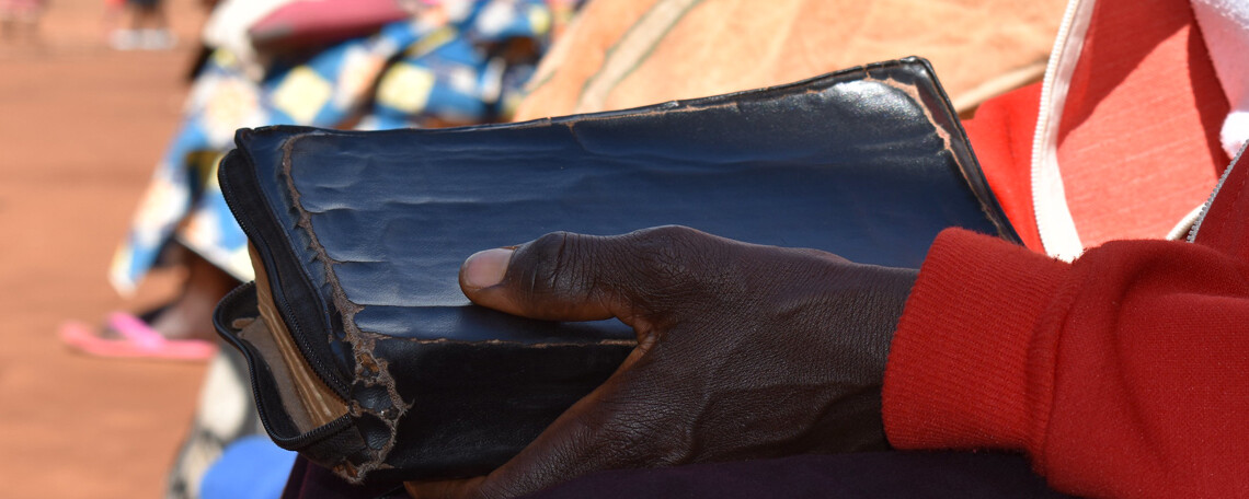 Close up of a bible held by a woman