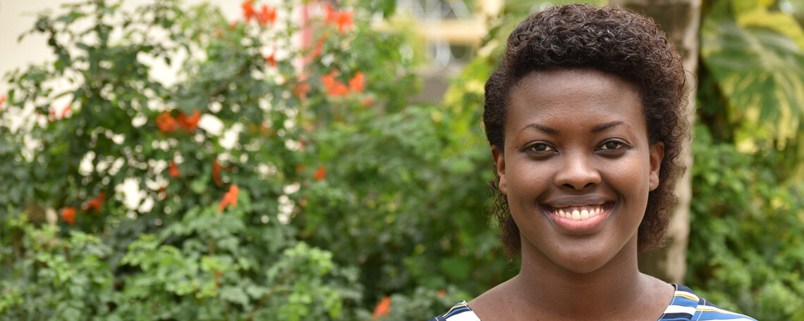 aimee smiles in a leafy courtyard